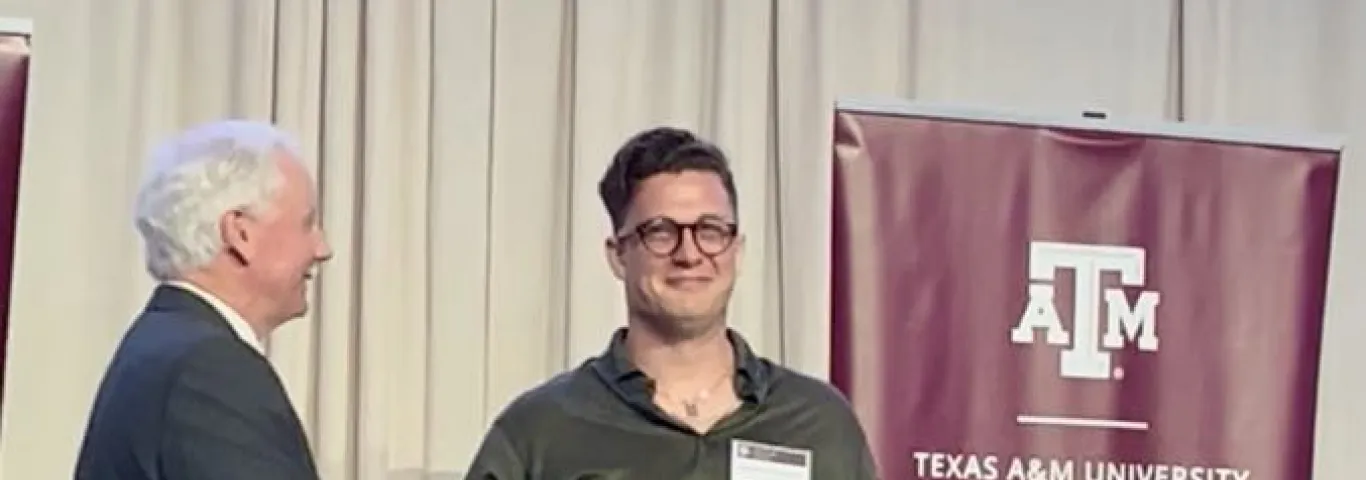 Karathanasis receiving award on a stage