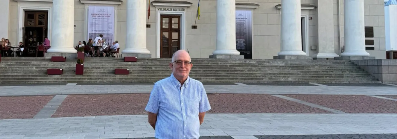 Tim Moore standing in front of a columned building in Vilinus