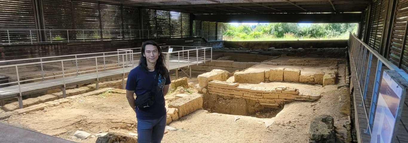Erdman standing at an archeological site