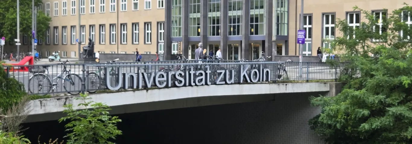 University of Cologne sign in German on a bridge