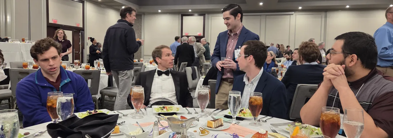DGS, Tom Keeline, chats with grad students at CAMWS dinner