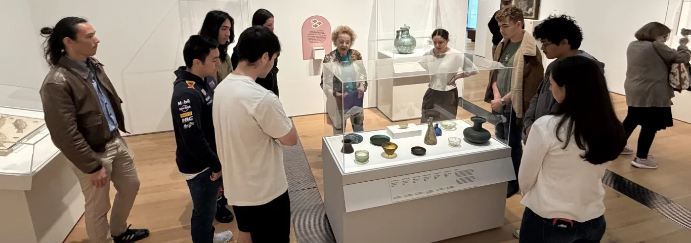 students and Professor Erdman study artifacts with docent
