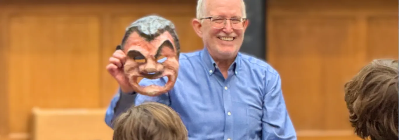 Moore holding a Roman theater mask 