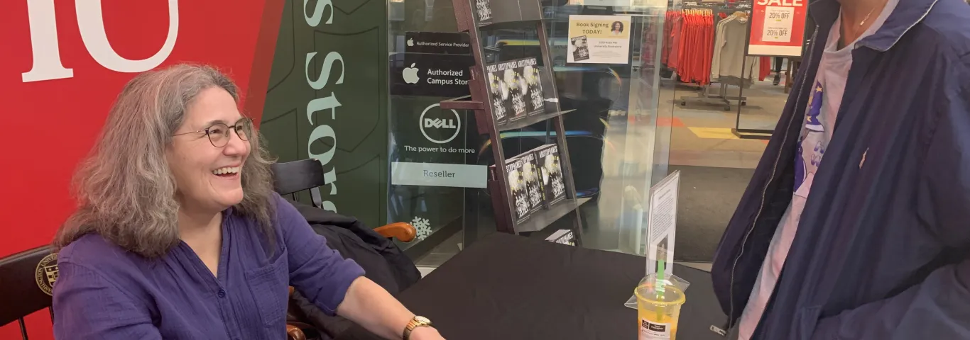 Diane speaking to a student at her book signing