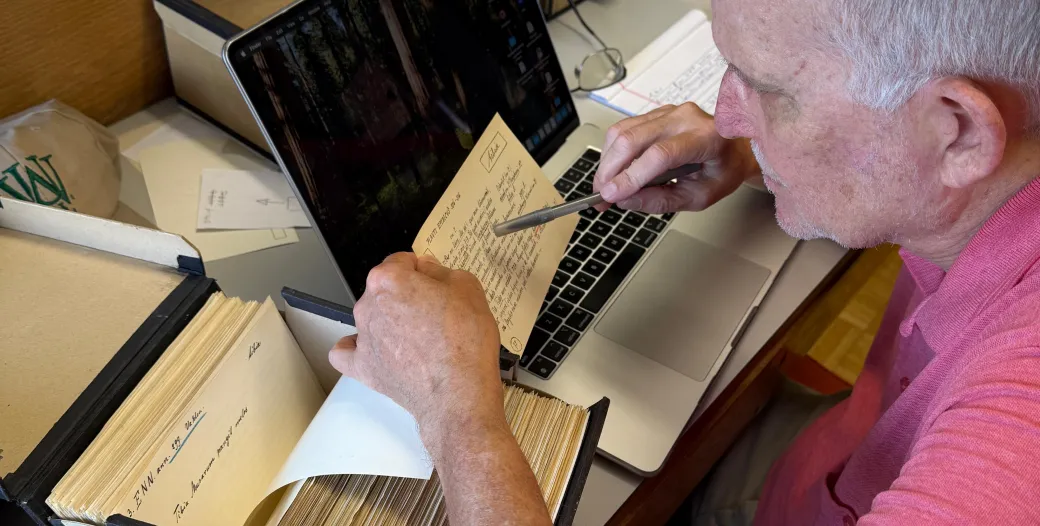 Moore studying an index card with his laptop open