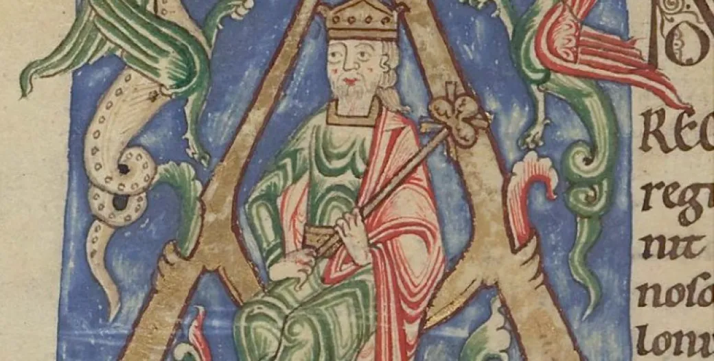 Illuminated Latin text with a kingly figure flanked by dragons