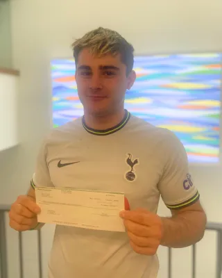 Aaron Held holding a check