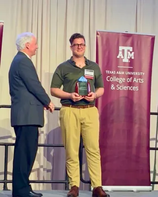 Karathanasis receiving award on a stage
