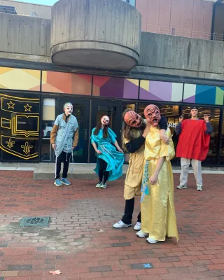 students in masks dancing and acting