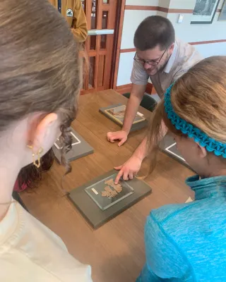 Will Sieving pointing to a papyrus fragment