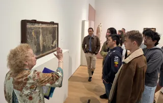 a SLAM docent speaks about a mosaic