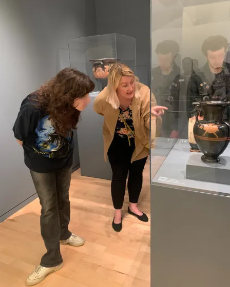WahshU faculty member and Clayton high student observe an ancient Greek vase in the Kemper