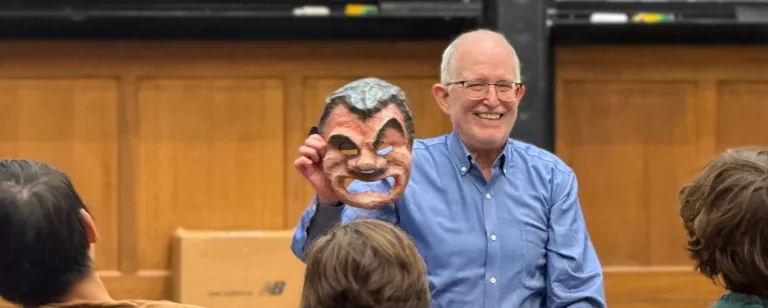 Tim Moore holding a Greek theatre mask