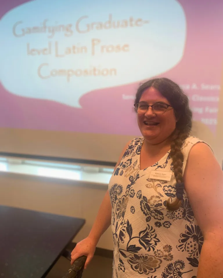 Sears standing in front of a screen with a slide that reads Gamifying Graduate-level Latin Prose Composition