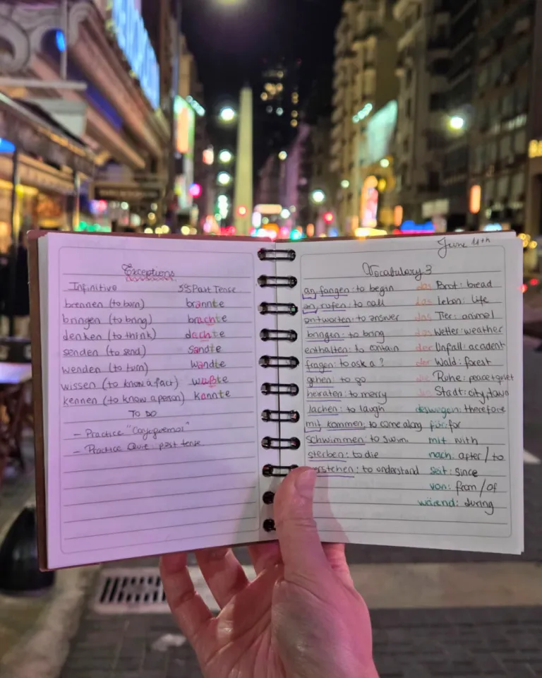 Notebook filled with German notes framed by the Buenos Aires skyline