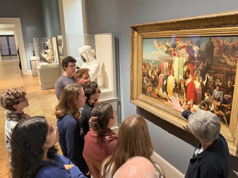a SLAM docent speaks about a painting to a group of students