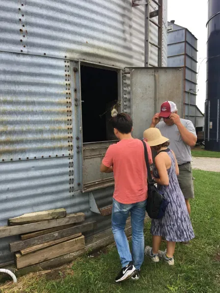 students peer into a siloah at a Missouri farm