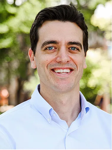 Man standing before a blurred background in a professional photo