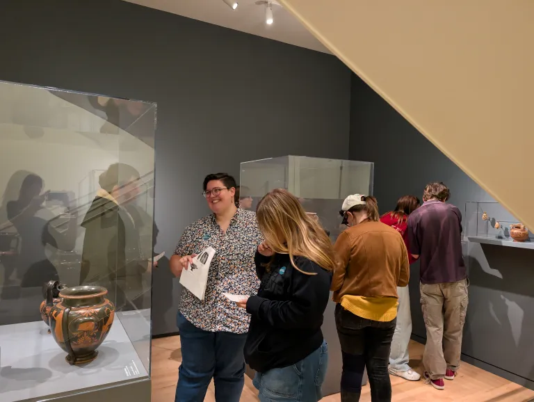students viewing and studying ancient Greek vases in a museum