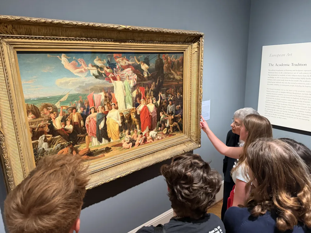 a student points to a painting