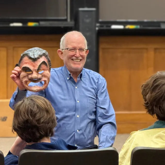 Moore holding a Roman theater mask 