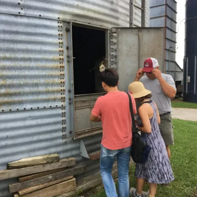 students peer into a siloah at a Missouri farm
