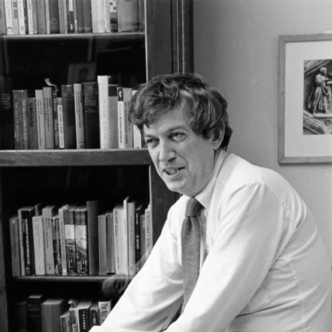 black and white picture of Redfield in front of a bookcase