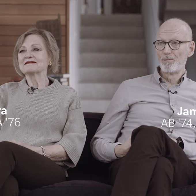 "Two people sitting on a couch"