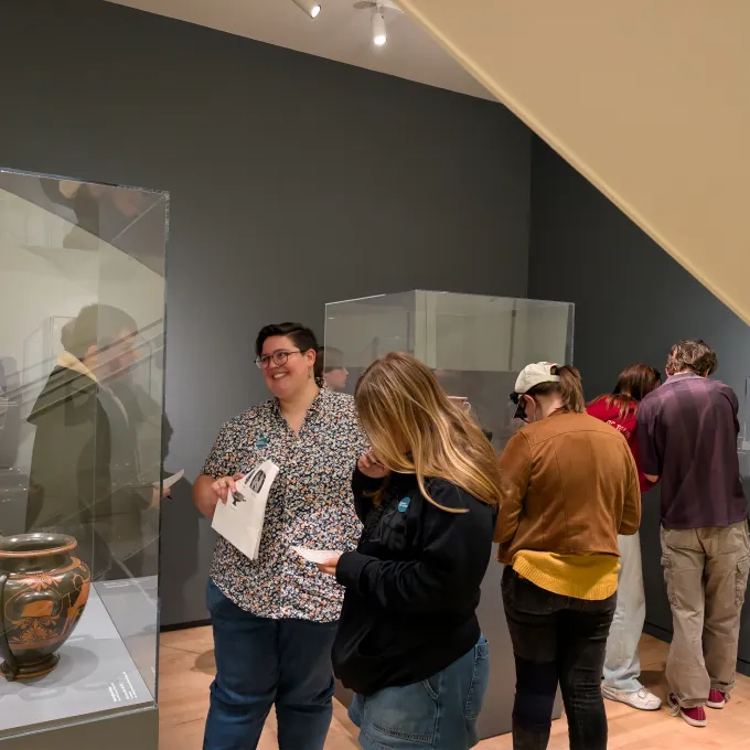 students viewing and studying ancient Greek vases in a museum